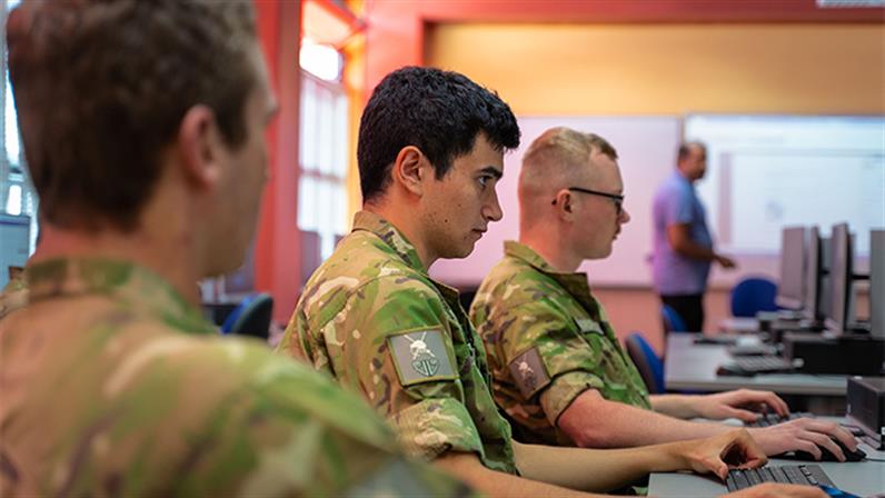 Defence force cadets sitting at computers