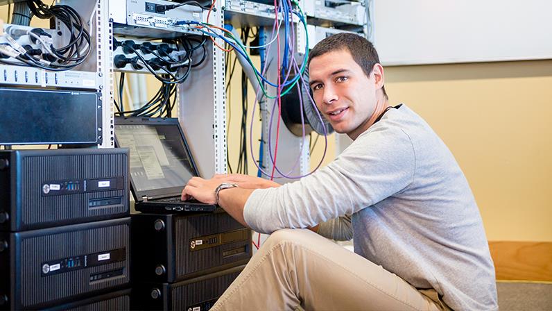 A UCOL learner working on a computer network.