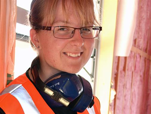 A young lady in a construction uniform