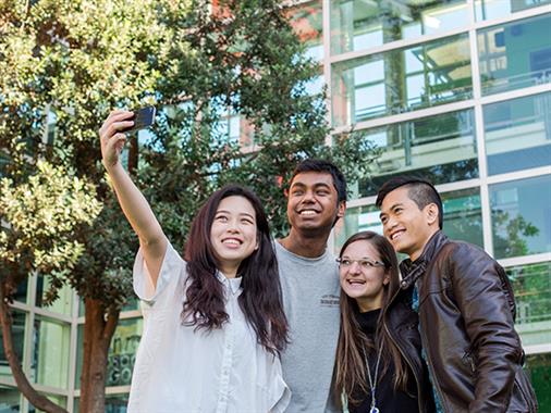 A photograph of a group of young people taking a selfie
