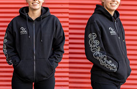 A photograph of a woman wearing the UCOL Black Zip Hoodie