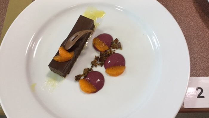 Chocolate mousse with mandarin sauce and poached mandarins