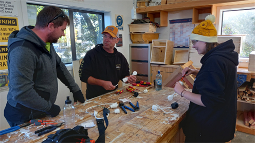 Dillan Wyse from McKenzies Electrical 2000 teaches practical skills to Aaron Middleton and Caitlyn Wilkins.  