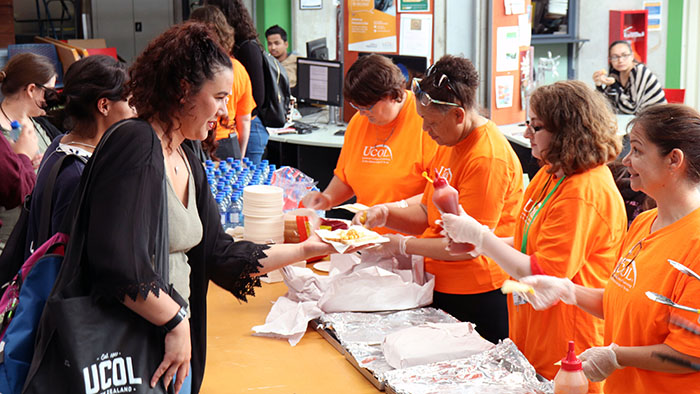 UCOL staff serving hot food to students