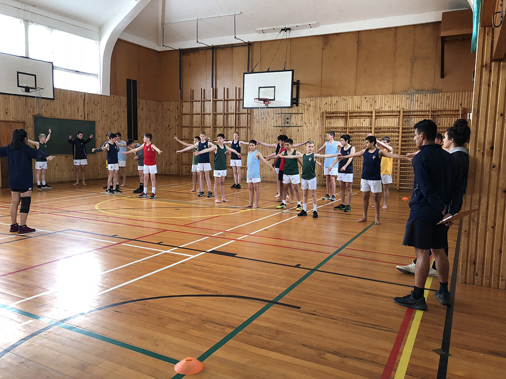 Students exercising in an indoor court