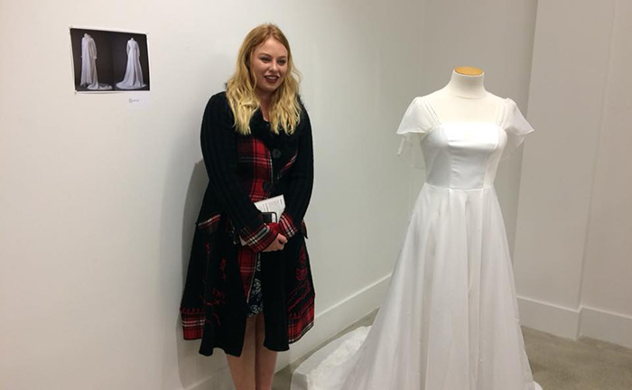 Paige MacDonald with a dress that she has created
