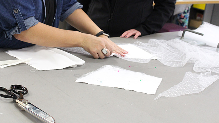 Closeup of student cutting material