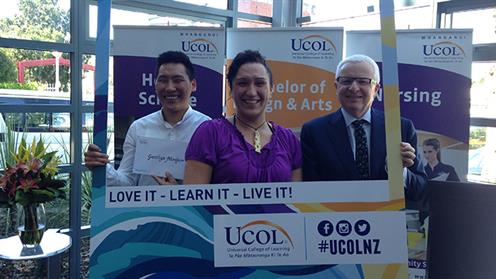 Three people holding a UCOL scholarship