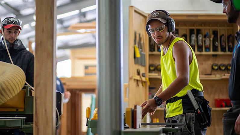 A carpentry student works on a cutting machine at UCOL in Palmerston North