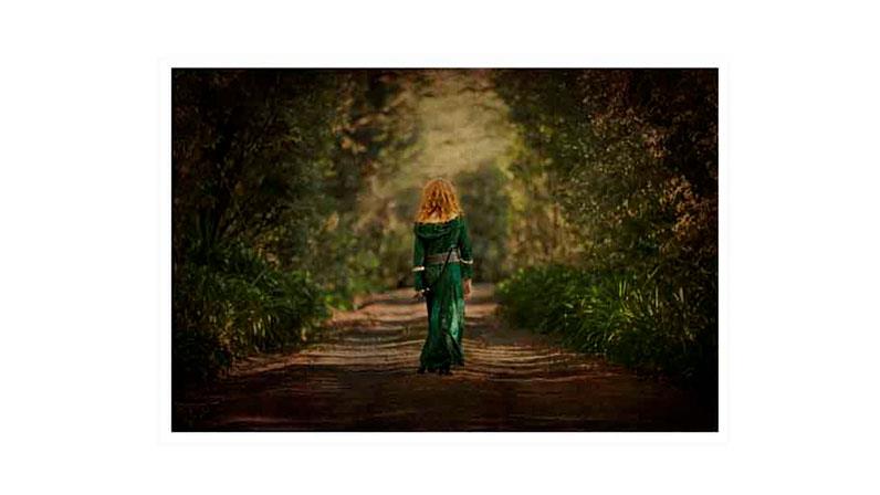 Person in green dress walking up pathway