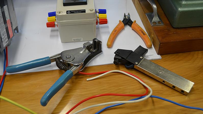 A photograph of a few electrical equipment on a wooden table