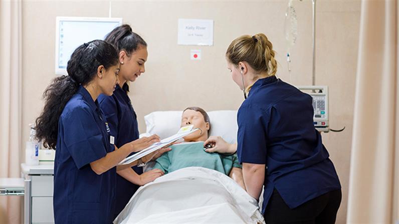 A photograph of UCOL nursing students administrating a dummy patient