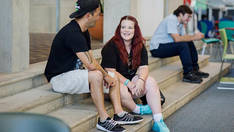 A photograph of students chatting in the Palmerston North atrium