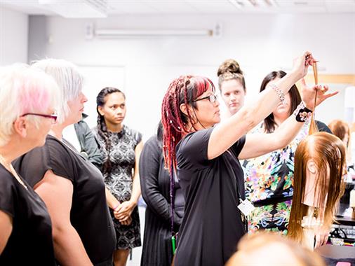 A photograph of a hairdressing training class