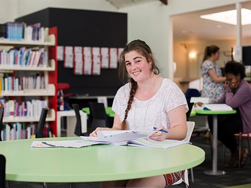 A photograph of a student in a library