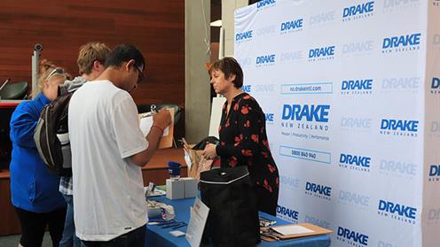 Drake employee speaking with students at the UCOL employment expo