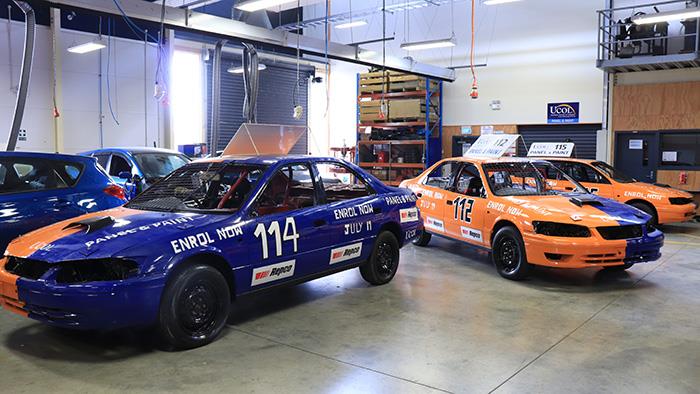 A photograph of UCOL speedway cars in the automotive workshop