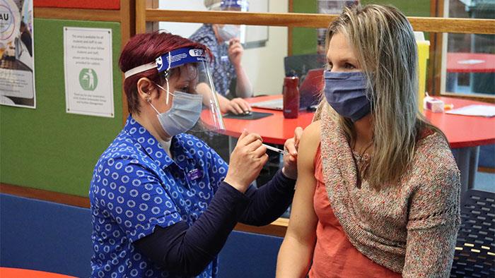 : Dr Dorota Starzak receives her first COVID-19 vaccination at a pop-up clinic at UCOL Manawatū