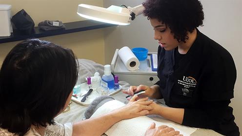 A photograph of a UCOL Certificate in Beauty Services student performing a manicure