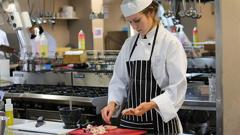 A photograph of Kate Farrington competing at UCOL's Live Kitchen Competition in Palmerston North