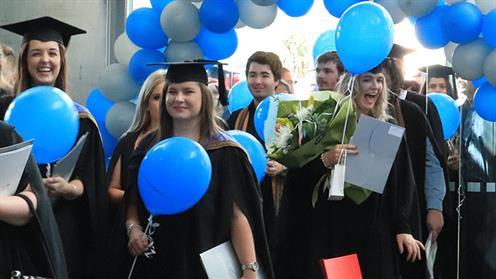 A photograph of UCOL graduates enjoying the parade in Palmerston North