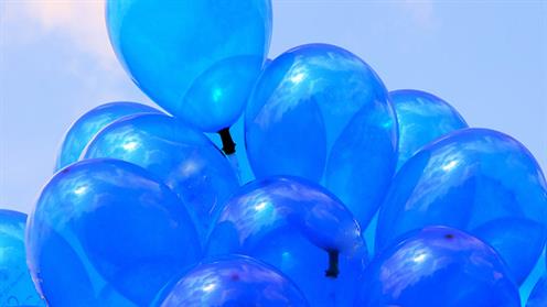 A photograph of a bunch of blue balloons