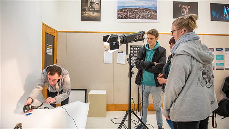 A UCOL students learning about lighting at the inhouse photography studio