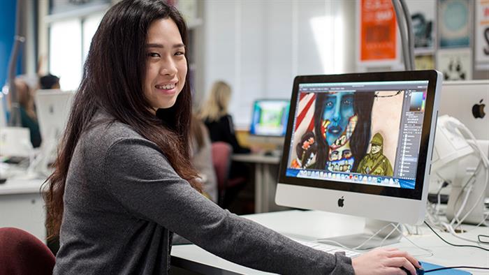 A lady studying at a computer with illustrations on the screen