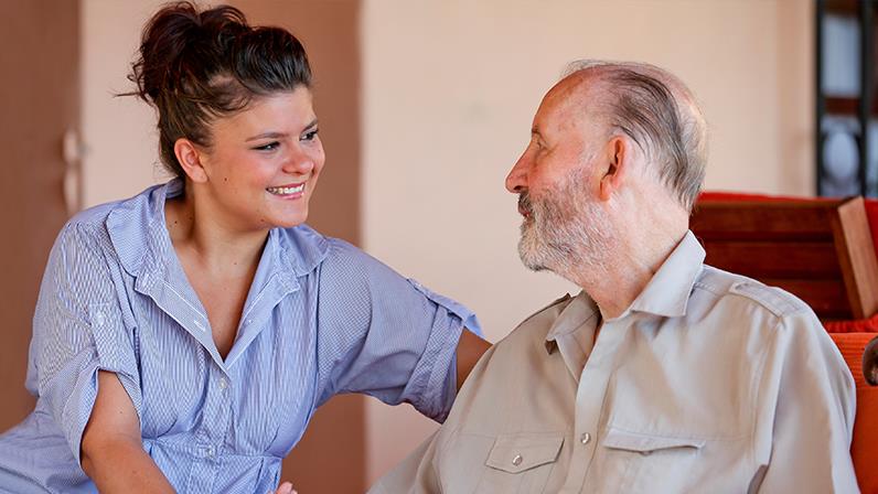 A young person talking to a elderly person