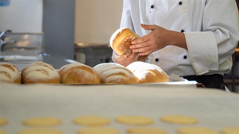A photograph of a student baking bread