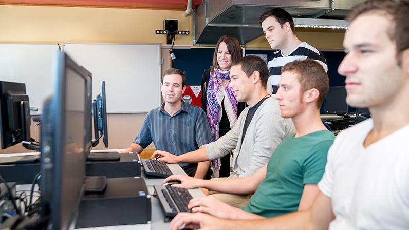 A group of student working at desktop computers.