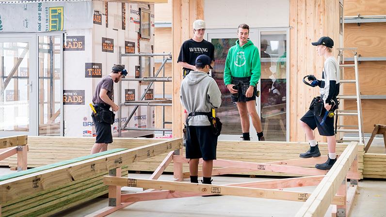 Students working with timber at UCOL | Te Pūkenga construction facility