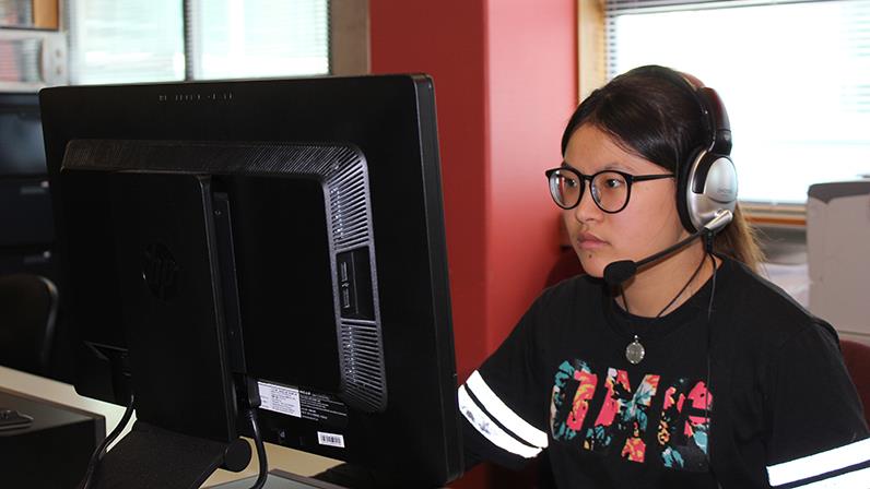 A photograph of a UCOL student taking the TOEFL iBT Test online
