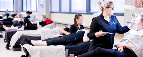A photograph of UCOL beauty students performing services on clients in the salon