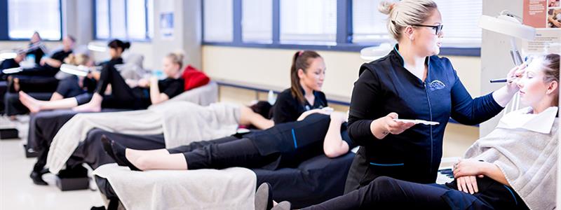 A photograph of UCOL beauty students performing services on clients in the salon