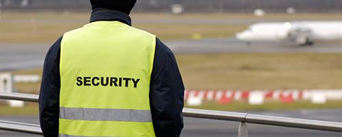 A security guard stands watching at an airport