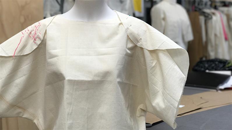 A garment tacked together on a model