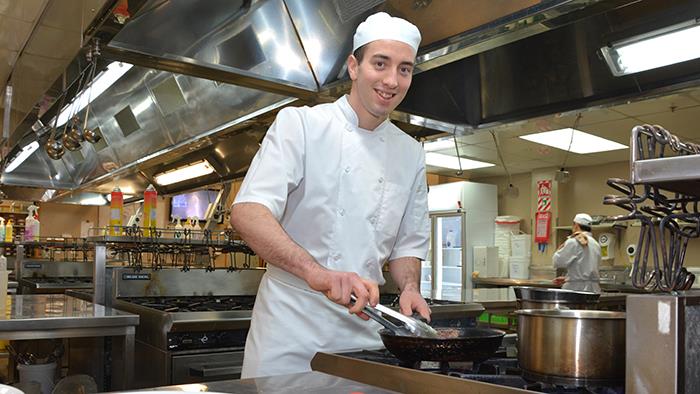 A photograph of Zach Means in UCOL's commercial kitchen