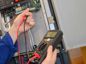 A learner taking an electrical reading