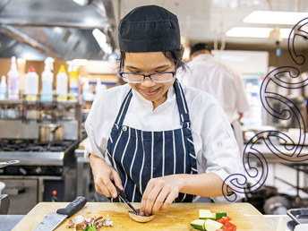 A chef prepping a dish.