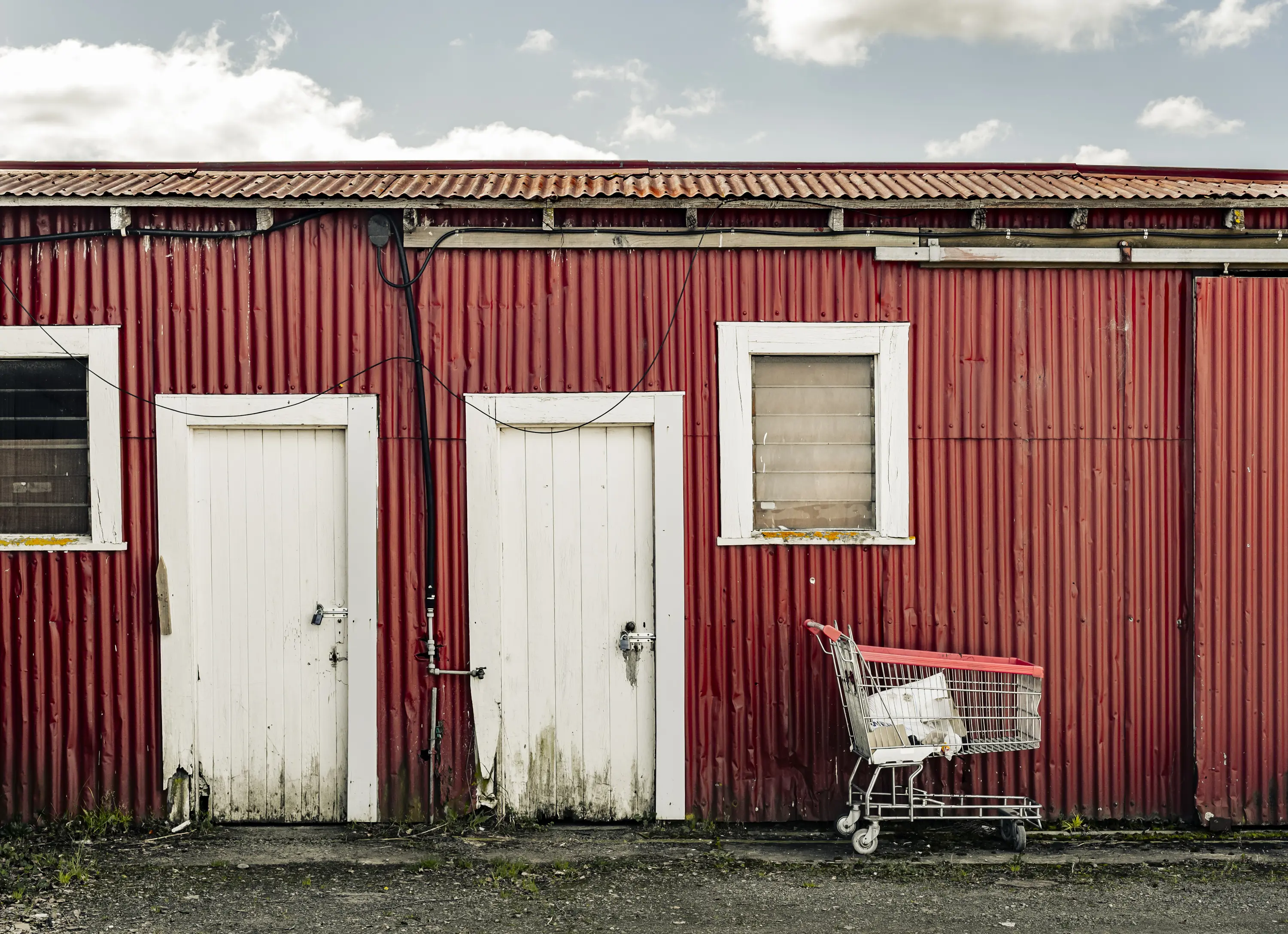 a red building with a shopping cart in front of it
