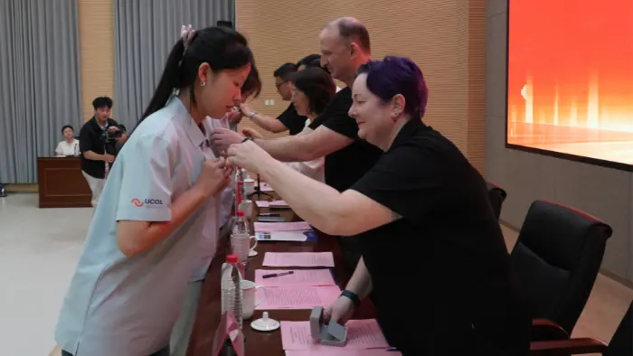 a group of people standing around a table