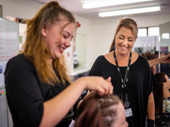 A UCOL student dressing a client's hair at one of UCOL's hair saloon