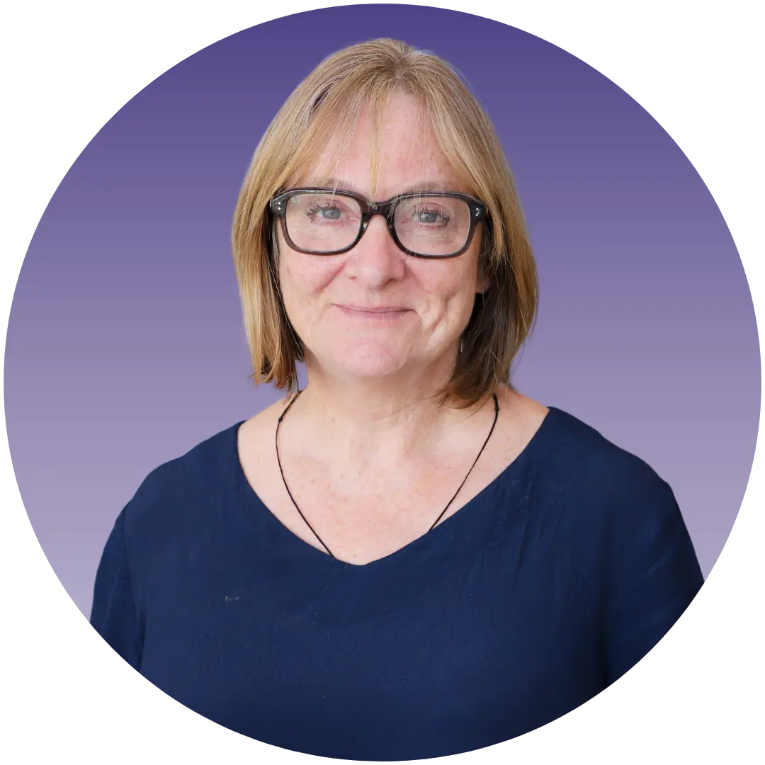 a woman wearing glasses and a blue shirt