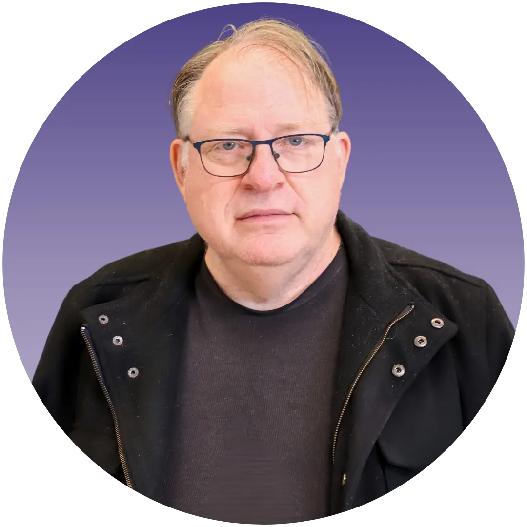 a man wearing glasses and a black jacket