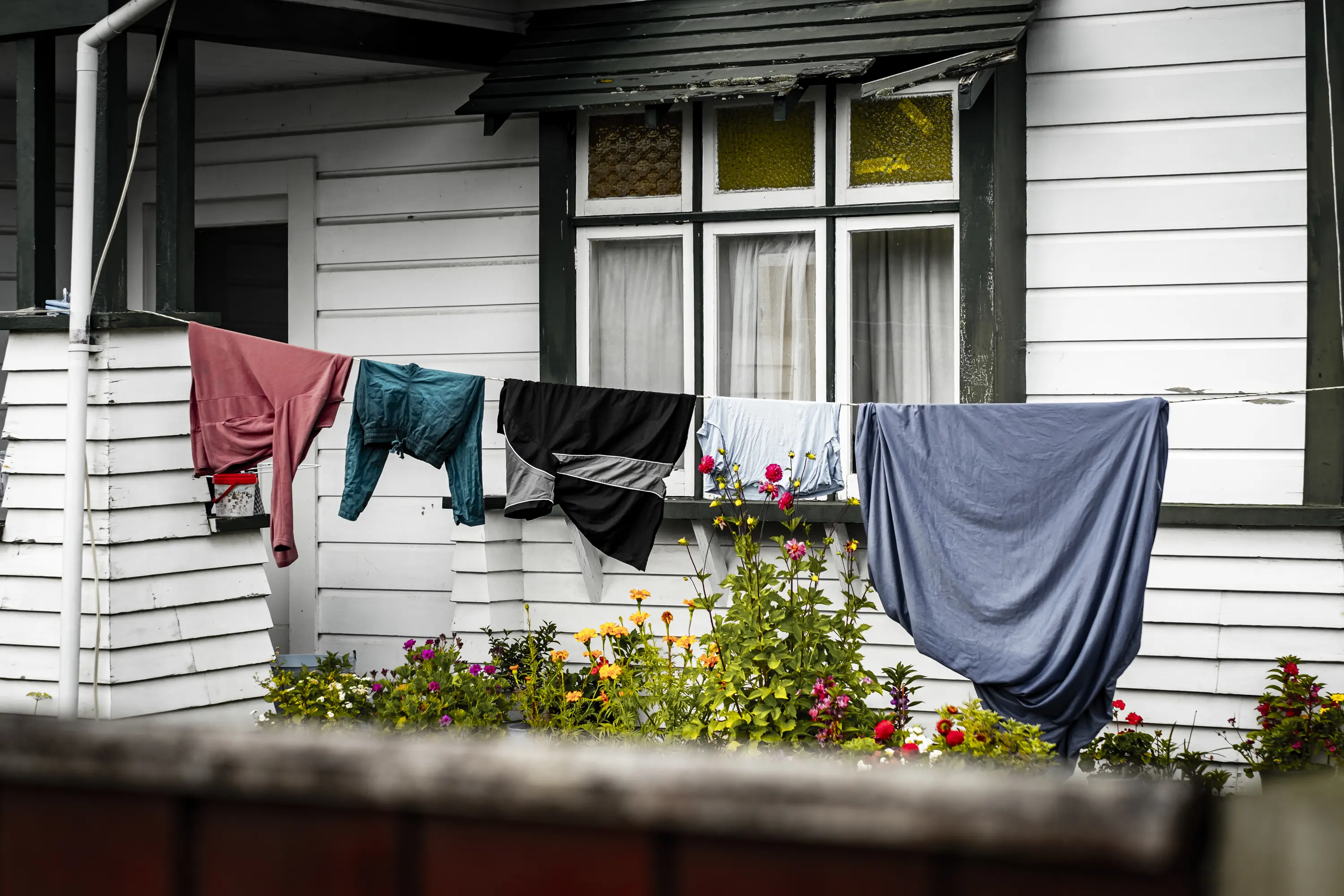 clothes on a clothesline outside of a house