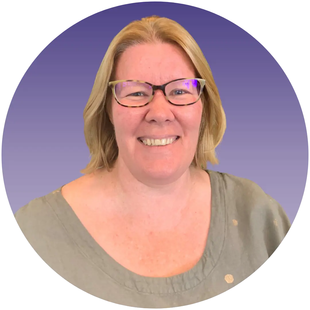 a woman wearing glasses smiling
