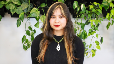 a woman with long hair and a necklace