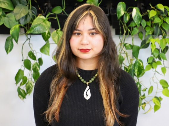a woman with long hair and a necklace