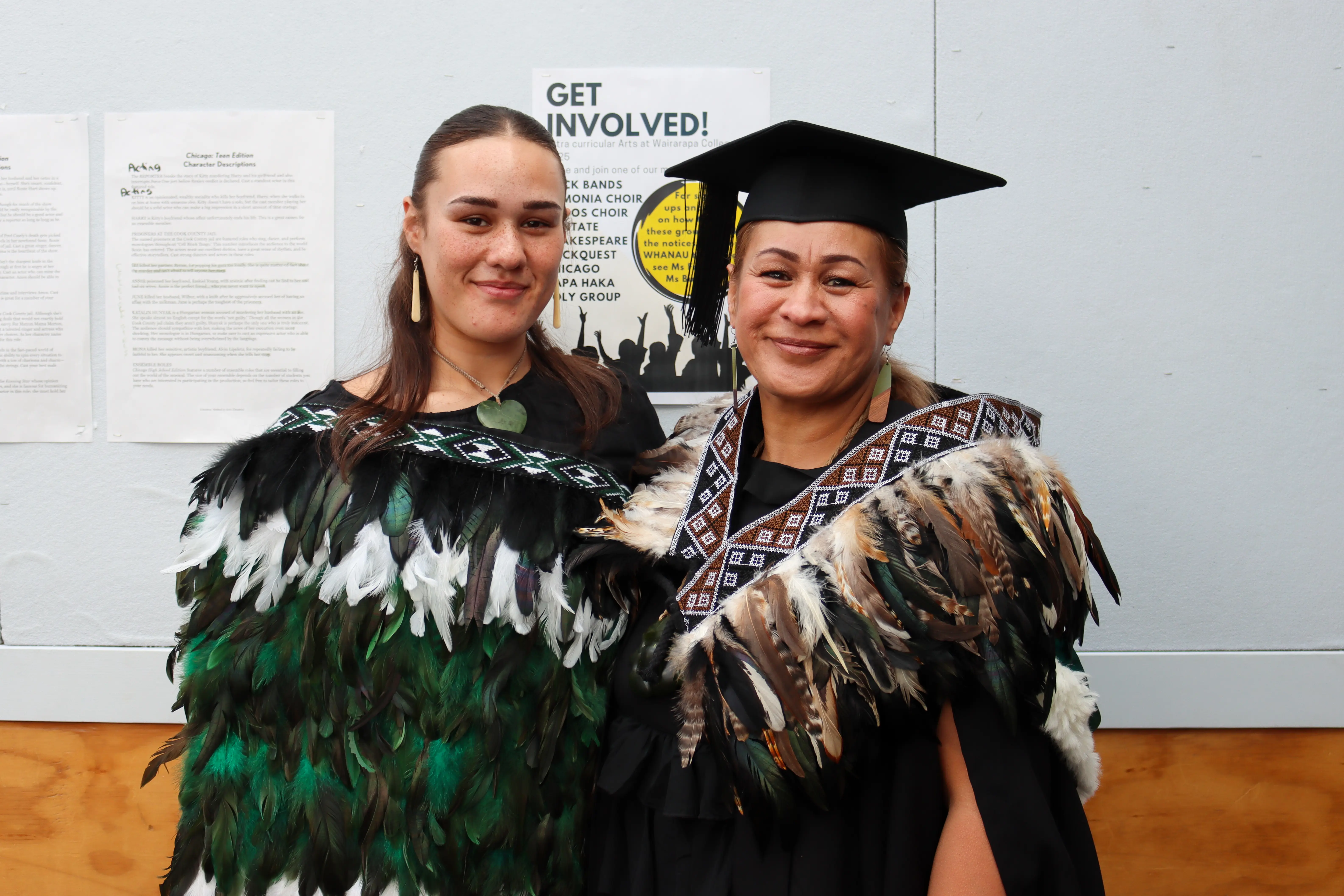 two women wearing a graduation cap and gown